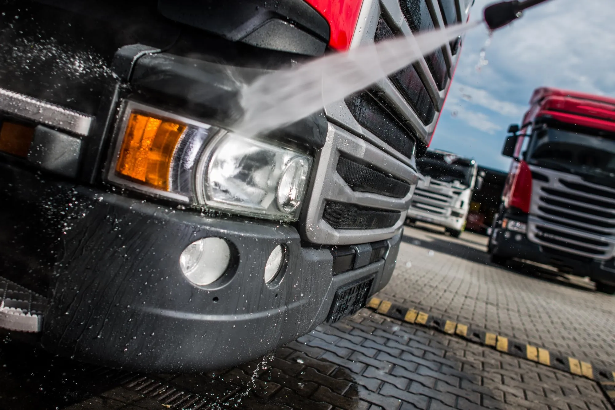 A lineup of clean trucks after receiving pressure washing services