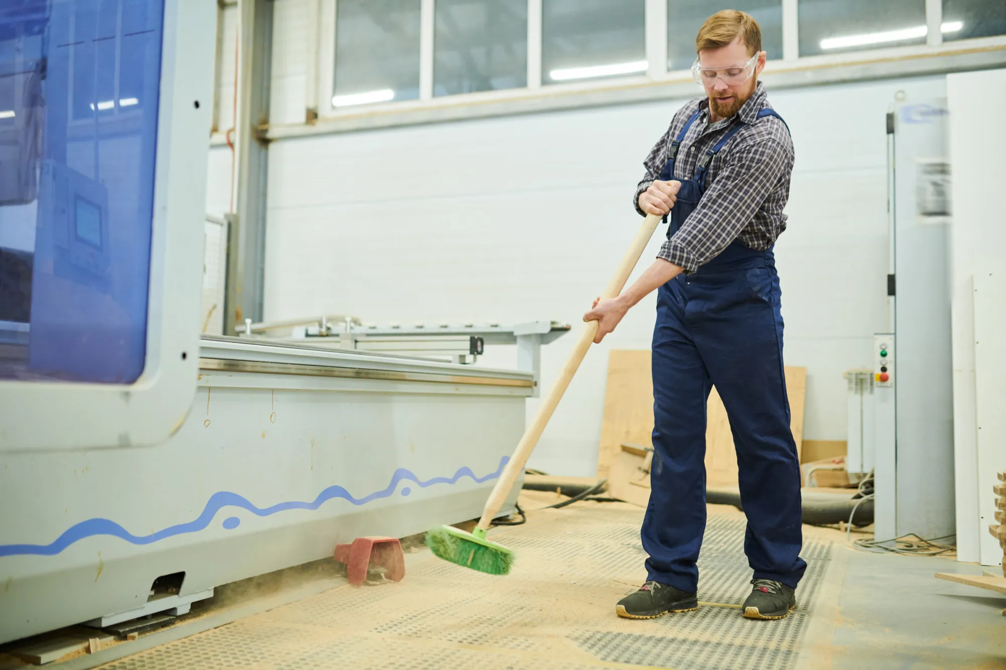 A pressure washer being used to clean a heavily trafficked warehouse aisle.