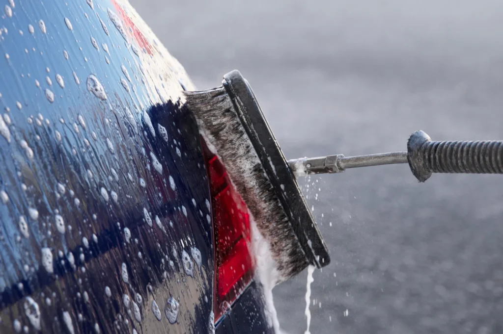 A professional cleaning truck being pressure washed for maintenance