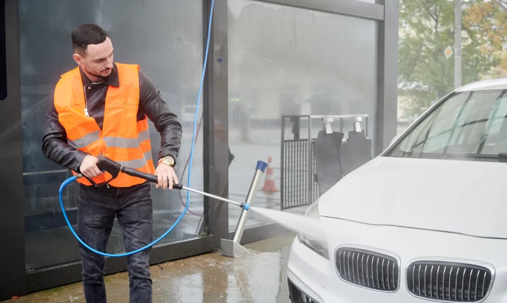 Professional pressure washing in an underground parkade.