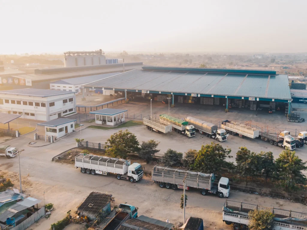 A row of clean fleet trucks parked at a service station.