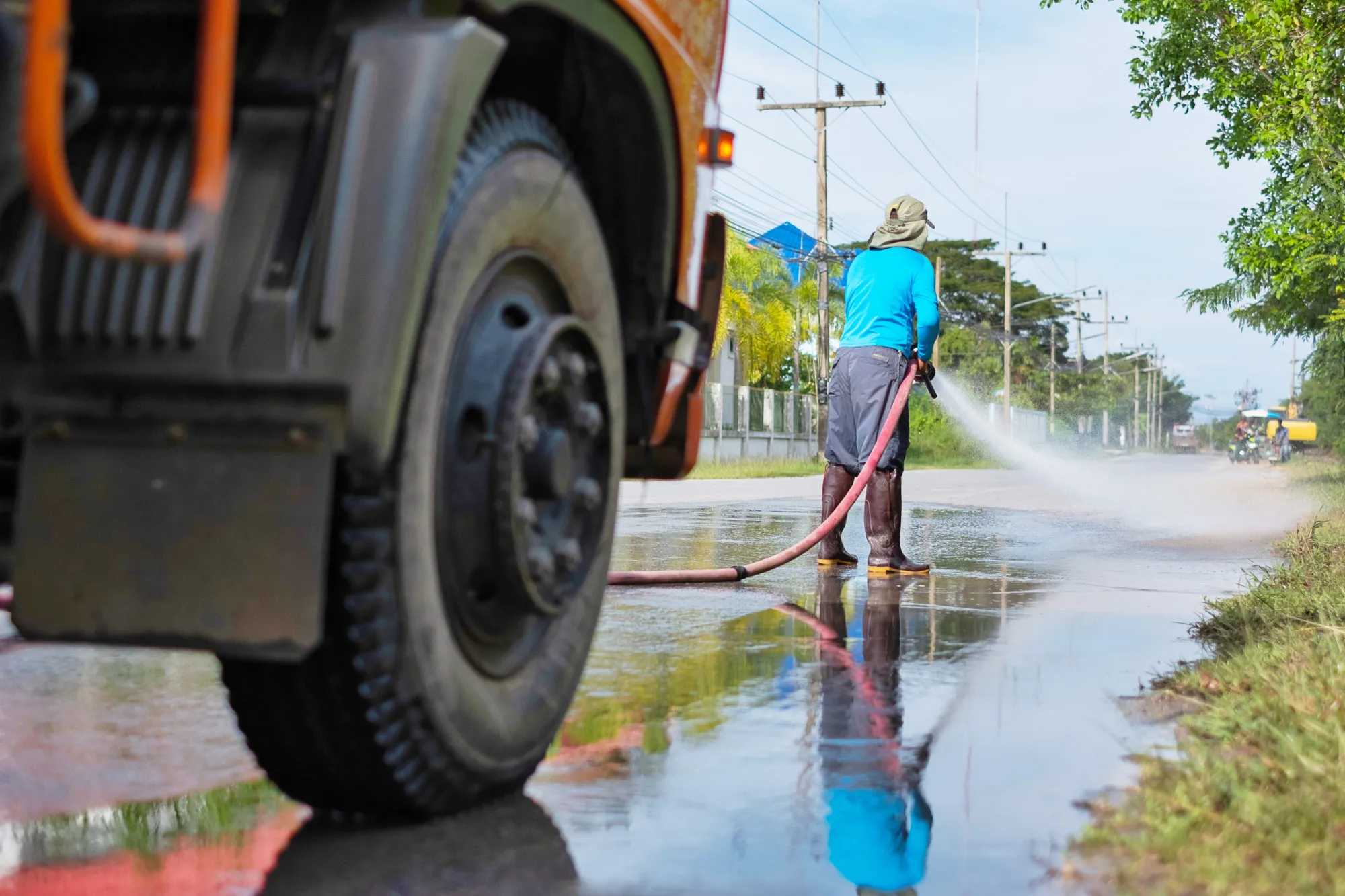 A fleet truck being pressure-washed with a water recovery system.